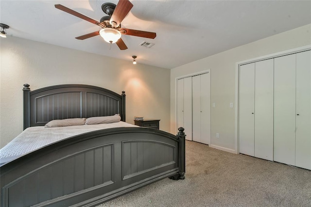 8800 Stoneleigh Ct, Oklahoma City, OK 73132 - bedroom with multiple closets, carpet flooring, and a ceiling fan