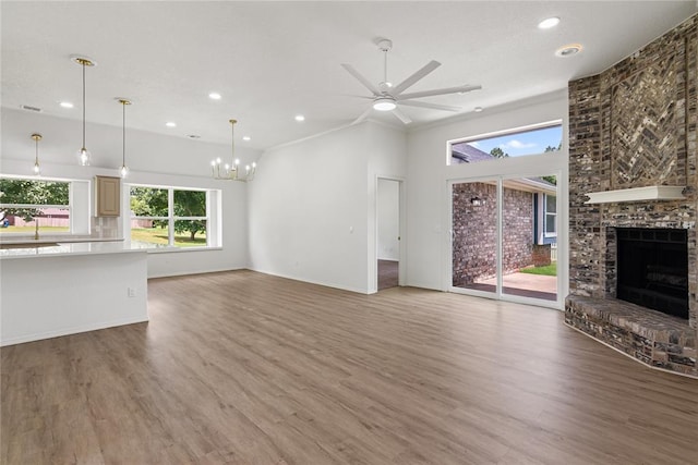 2719 NW 30th St, Newcastle, OK 73065 - unfurnished living room featuring ceiling fan, recessed lighting, a brick fireplace, a chandelier, and light wood-type flooring