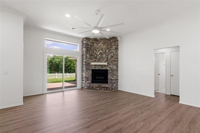 2719 NW 30th St, Newcastle, OK 73065 - unfurnished living room featuring ceiling fan, wood finished floors, a brick fireplace, crown molding, and recessed lighting