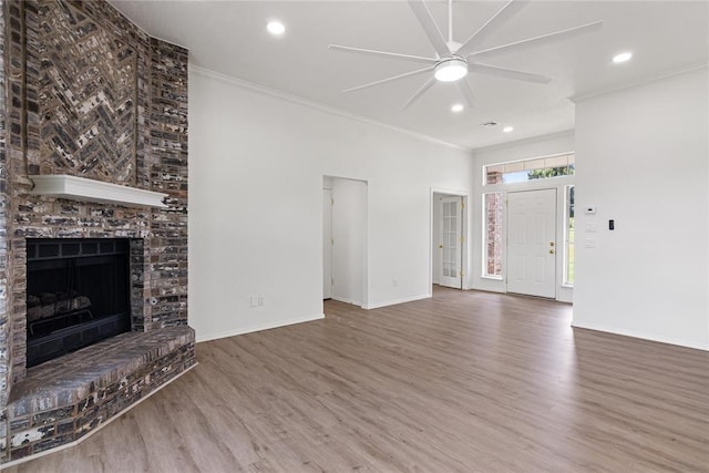2719 NW 30th St, Newcastle, OK 73065 - unfurnished living room featuring wood finished floors, a ceiling fan, crown molding, recessed lighting, and a fireplace