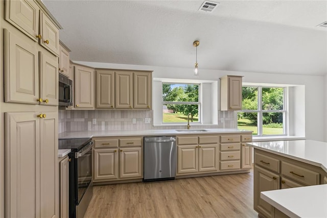 2719 NW 30th St, Newcastle, OK 73065 - kitchen featuring appliances with stainless steel finishes, light countertops, plenty of natural light, tasteful backsplash, and vaulted ceiling