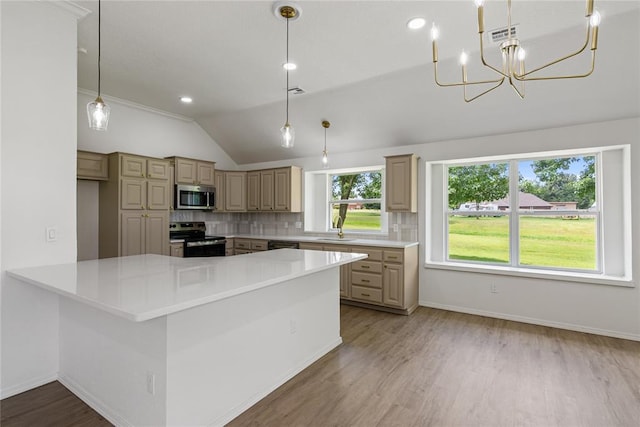 2719 NW 30th St, Newcastle, OK 73065 - kitchen with stainless steel appliances, vaulted ceiling, light countertops, wood finished floors, and backsplash