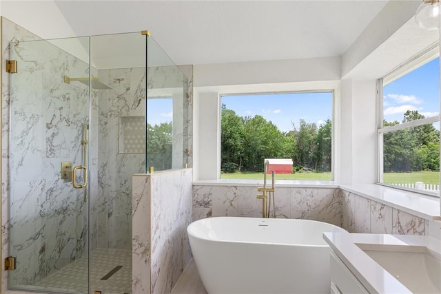 2719 NW 30th St, Newcastle, OK 73065 - bathroom featuring a freestanding bath, a marble finish shower, tile walls, and vanity