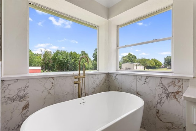 2719 NW 30th St, Newcastle, OK 73065 - bathroom featuring a soaking tub and tile walls