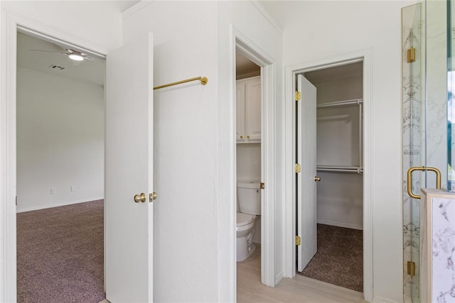 2719 NW 30th St, Newcastle, OK 73065 - bathroom with a marble finish shower, a walk in closet, and wood finished floors