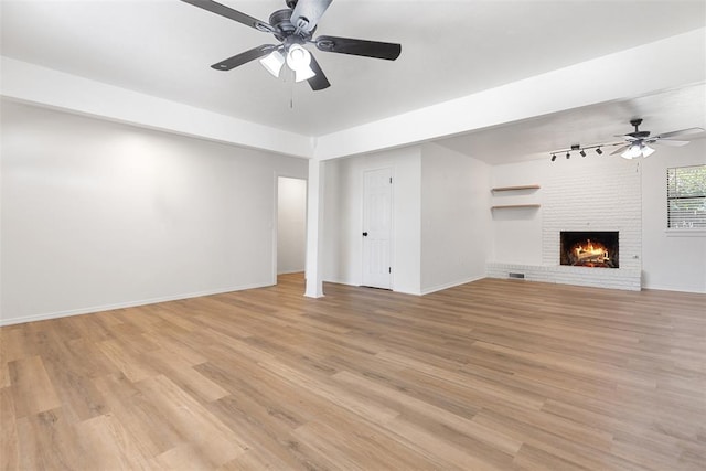 9617 Georgia Ave, Oklahoma City, OK 73120 - unfurnished living room featuring ceiling fan, light wood-style floors, and a fireplace