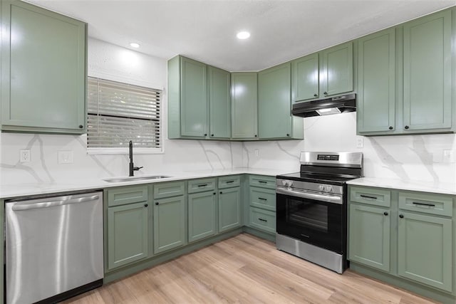 9617 Georgia Ave, Oklahoma City, OK 73120 - kitchen with stainless steel appliances, green cabinetry, under cabinet range hood, light wood-style floors, and recessed lighting
