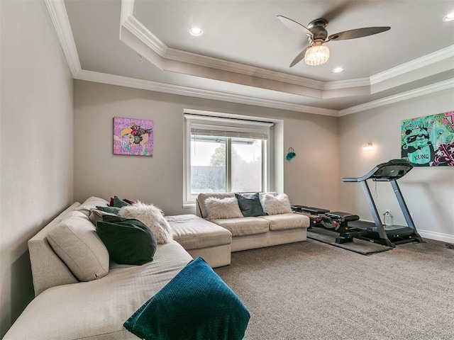 7032 NW 159th Pl, Edmond, OK 73013 - living room featuring a raised ceiling, crown molding, ceiling fan, and carpet floors