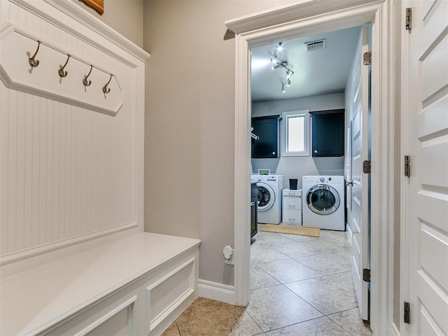 7032 NW 159th Pl, Edmond, OK 73013 - washroom with cabinet space, washer and clothes dryer, and light tile patterned floors