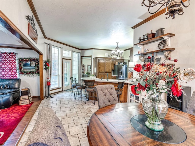 117 S Lexington Way, Edmond, OK 73012 - dining room featuring a chandelier, ornamental molding, and stone tile flooring
