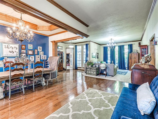 117 S Lexington Way, Edmond, OK 73012 - living area with a chandelier, ornamental molding, and wood-type flooring