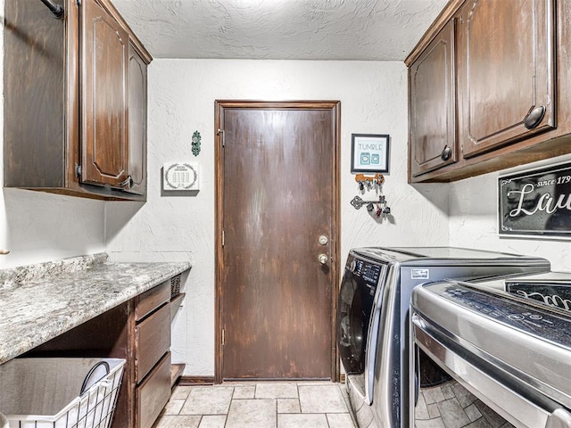 117 S Lexington Way, Edmond, OK 73012 - laundry area with washer and clothes dryer, cabinet space, a textured wall, and a textured ceiling