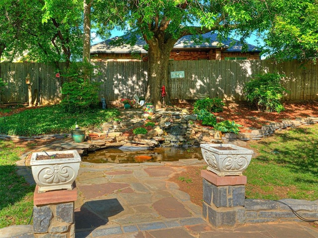 117 S Lexington Way, Edmond, OK 73012 - fenced backyard featuring a patio
