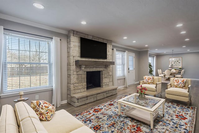 10900 Rock Ridge Rd, Oklahoma City, OK 73120 - living room with ornamental molding, recessed lighting, wood finished floors, and a stone fireplace