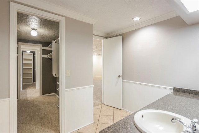 10900 Rock Ridge Rd, Oklahoma City, OK 73120 - bathroom featuring a textured ceiling, vanity, recessed lighting, a spacious closet, and ornamental molding