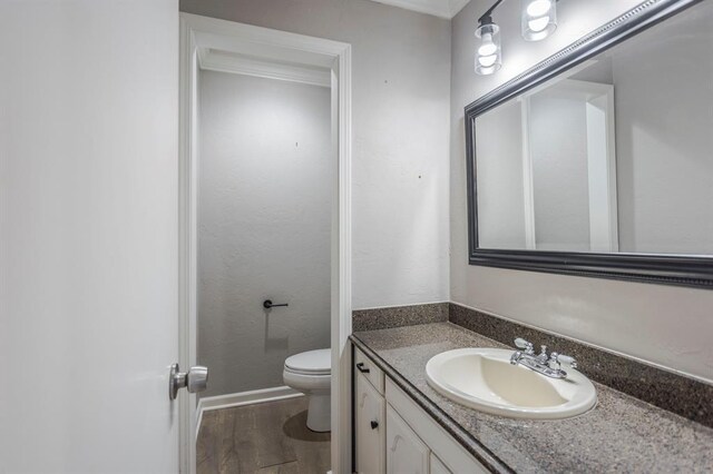 10900 Rock Ridge Rd, Oklahoma City, OK 73120 - bathroom with vanity, wood finished floors, and ornamental molding