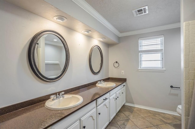 10900 Rock Ridge Rd, Oklahoma City, OK 73120 - bathroom with ornamental molding, double vanity, a textured ceiling, and tile patterned floors