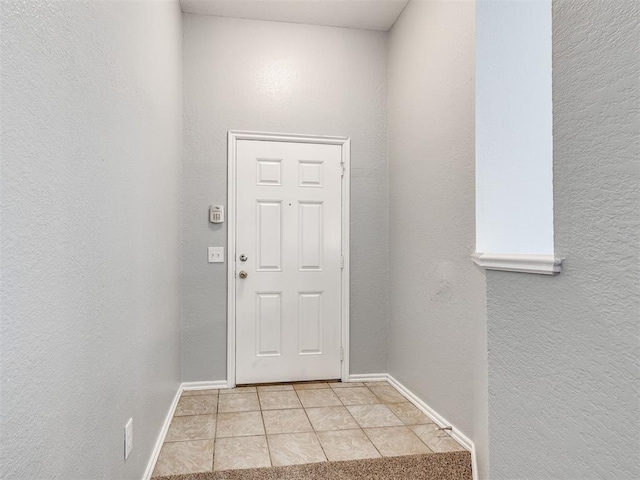 4917 SE 89th Ter, Oklahoma City, OK 73135 - entryway with light tile patterned flooring and a textured wall