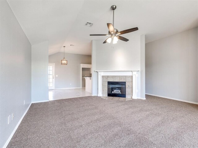 4917 SE 89th Ter, Oklahoma City, OK 73135 - unfurnished living room featuring carpet floors, lofted ceiling, a ceiling fan, and a tiled fireplace