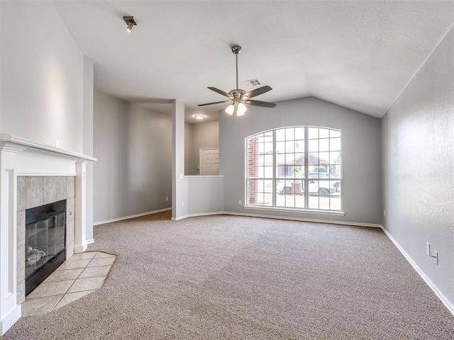 4917 SE 89th Ter, Oklahoma City, OK 73135 - unfurnished living room with carpet, a ceiling fan, lofted ceiling, and a tiled fireplace