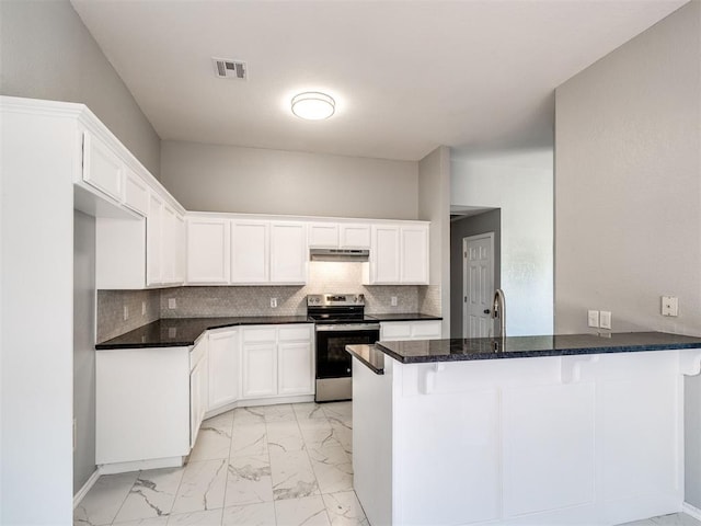 4917 SE 89th Ter, Oklahoma City, OK 73135 - kitchen with stainless steel electric stove, under cabinet range hood, a peninsula, light marble finish flooring, and white cabinetry