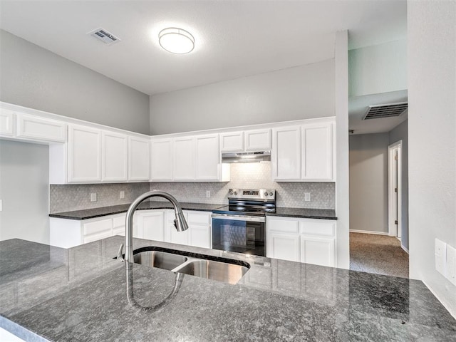 4917 SE 89th Ter, Oklahoma City, OK 73135 - kitchen with electric stove, under cabinet range hood, dark stone countertops, and white cabinetry