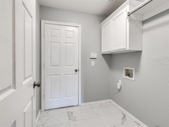 4917 SE 89th Ter, Oklahoma City, OK 73135 - laundry area featuring washer hookup, cabinet space, and light marble finish flooring