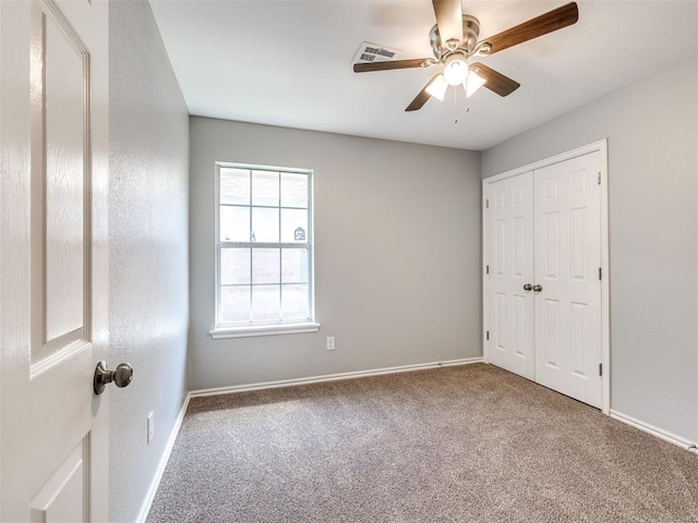 4917 SE 89th Ter, Oklahoma City, OK 73135 - unfurnished bedroom featuring carpet flooring, a closet, and a ceiling fan
