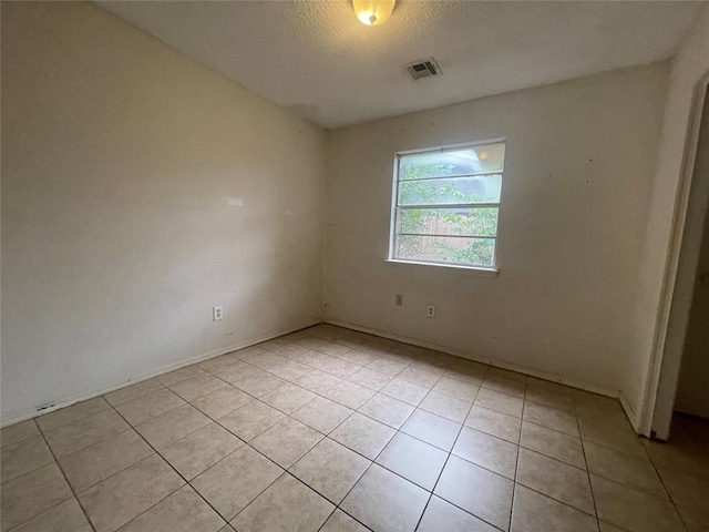 5333 Coble St, Oklahoma City, OK 73135 - spare room with light tile patterned flooring and a textured ceiling