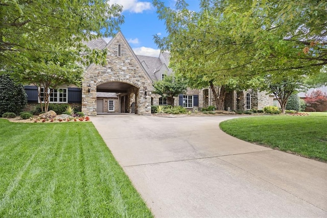 1608 Mulholland Dr, Edmond, OK 73003 - view of front of property featuring stone siding, curved driveway, and a front lawn
