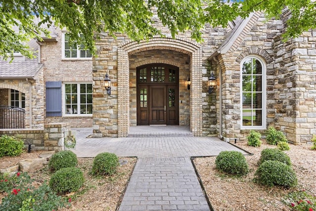1608 Mulholland Dr, Edmond, OK 73003 - property entrance featuring stone siding and brick siding