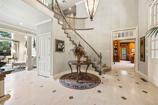 1608 Mulholland Dr, Edmond, OK 73003 - tiled foyer entrance featuring crown molding, stairway, a towering ceiling, and ornate columns