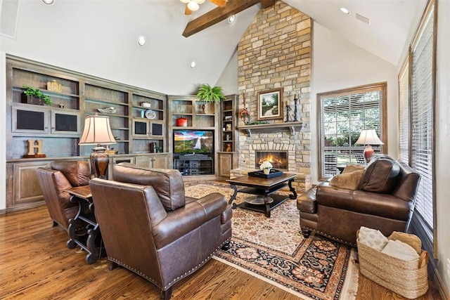 1608 Mulholland Dr, Edmond, OK 73003 - living area with beamed ceiling, a fireplace, wood finished floors, high vaulted ceiling, and ceiling fan