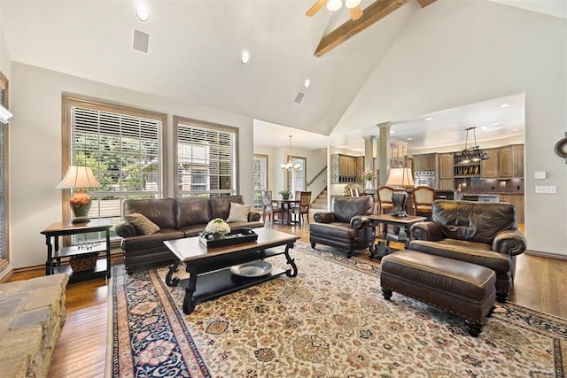 1608 Mulholland Dr, Edmond, OK 73003 - living area with high vaulted ceiling, a chandelier, wood finished floors, ceiling fan, and plenty of natural light