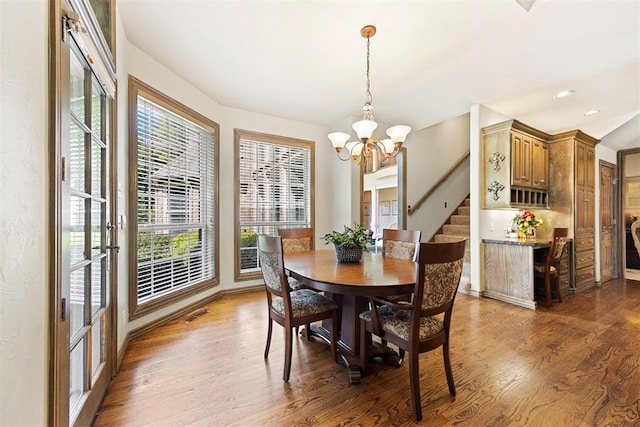 1608 Mulholland Dr, Edmond, OK 73003 - dining room with a chandelier, wood finished floors, stairs, and recessed lighting