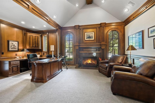 1608 Mulholland Dr, Edmond, OK 73003 - office with light colored carpet, high vaulted ceiling, a fireplace, built in desk, and wood walls