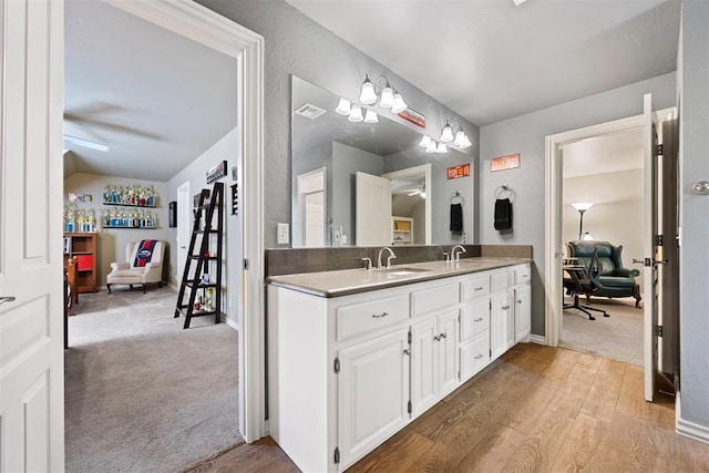 1608 Mulholland Dr, Edmond, OK 73003 - bathroom featuring double vanity and wood finished floors