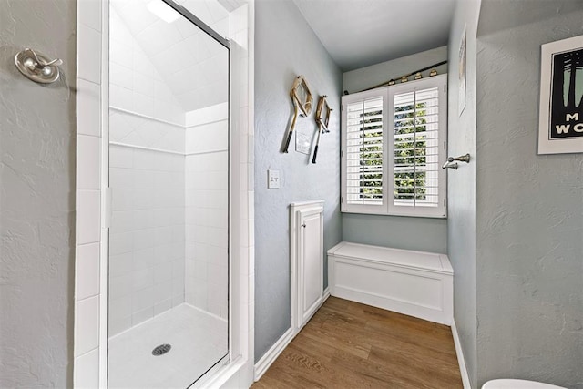 1608 Mulholland Dr, Edmond, OK 73003 - bathroom featuring wood finished floors, a shower stall, and a textured wall