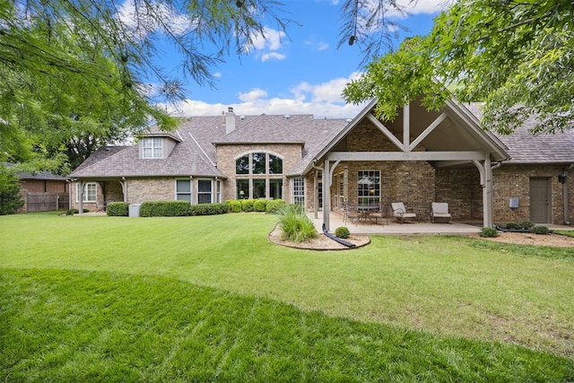 1608 Mulholland Dr, Edmond, OK 73003 - back of property with a chimney, brick siding, a patio, and a shingled roof