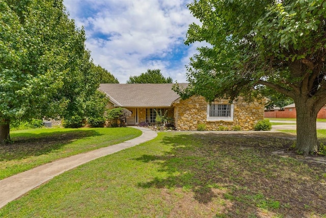 11900 Surrey Ln, Yukon, OK 73099 - ranch-style house featuring stone siding and a front lawn