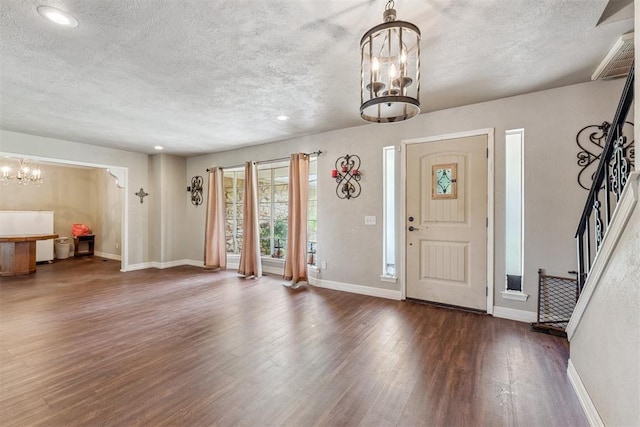 11900 Surrey Ln, Yukon, OK 73099 - foyer entrance with a chandelier, a textured ceiling, wood finished floors, and recessed lighting