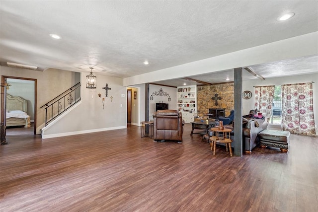 11900 Surrey Ln, Yukon, OK 73099 - living room with wood finished floors, a textured ceiling, stairway, recessed lighting, and built in features