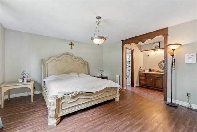 11900 Surrey Ln, Yukon, OK 73099 - bedroom featuring wood finished floors and connected bathroom