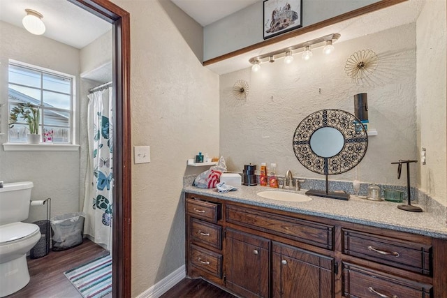 11900 Surrey Ln, Yukon, OK 73099 - bathroom featuring wood finished floors, vanity, a textured wall, track lighting, and a shower with shower curtain