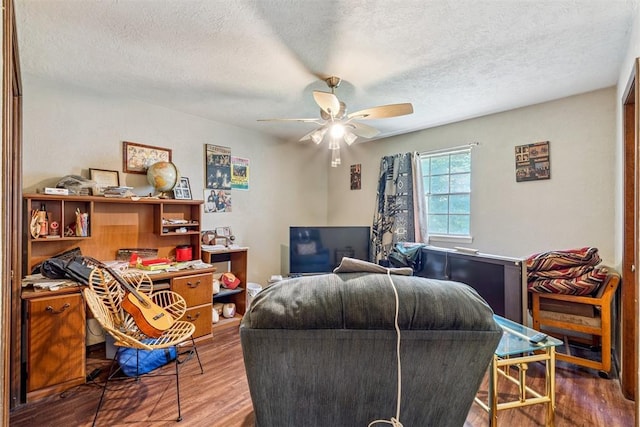 11900 Surrey Ln, Yukon, OK 73099 - living area featuring ceiling fan, wood finished floors, and a textured ceiling