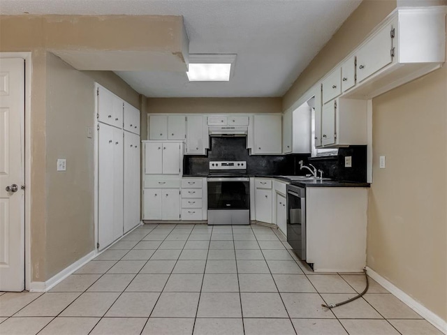 4113 Clendon Way, Del City, OK 73115 - kitchen featuring appliances with stainless steel finishes, dark countertops, tasteful backsplash, under cabinet range hood, and white cabinets