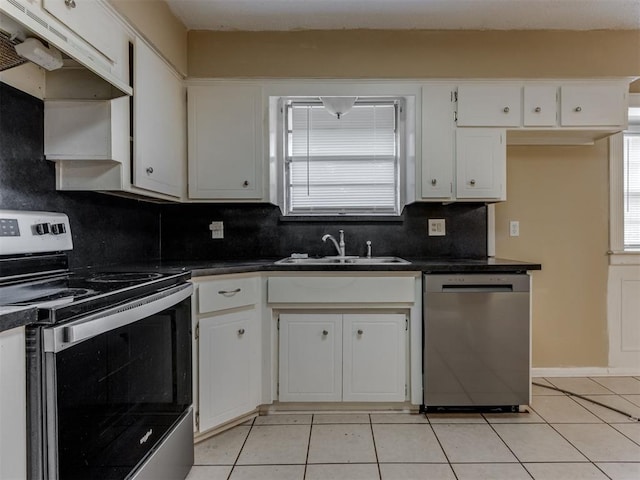 4113 Clendon Way, Del City, OK 73115 - kitchen with stainless steel appliances, under cabinet range hood, dark countertops, decorative backsplash, and light tile patterned floors