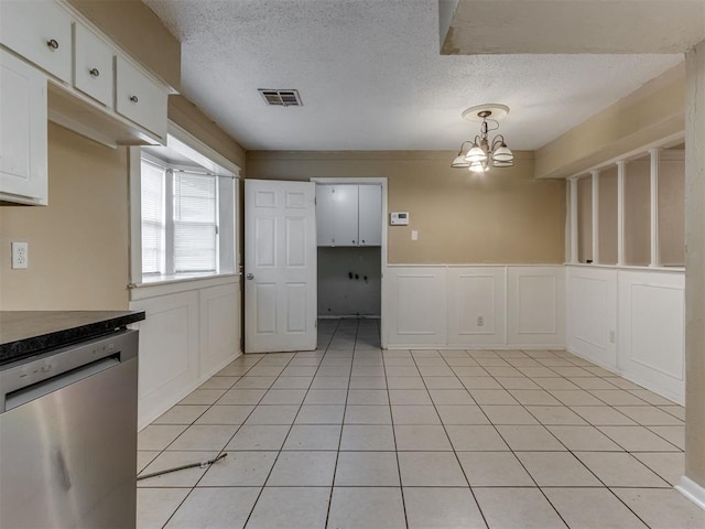 4113 Clendon Way, Del City, OK 73115 - unfurnished dining area featuring a chandelier, a textured ceiling, light tile patterned floors, and wainscoting
