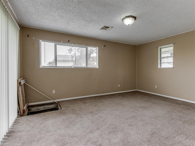4113 Clendon Way, Del City, OK 73115 - carpeted spare room featuring a textured ceiling and baseboards
