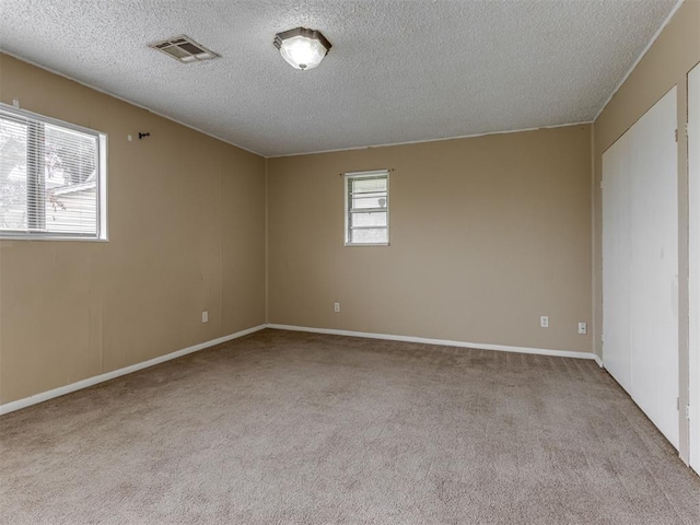 4113 Clendon Way, Del City, OK 73115 - carpeted spare room featuring a textured ceiling